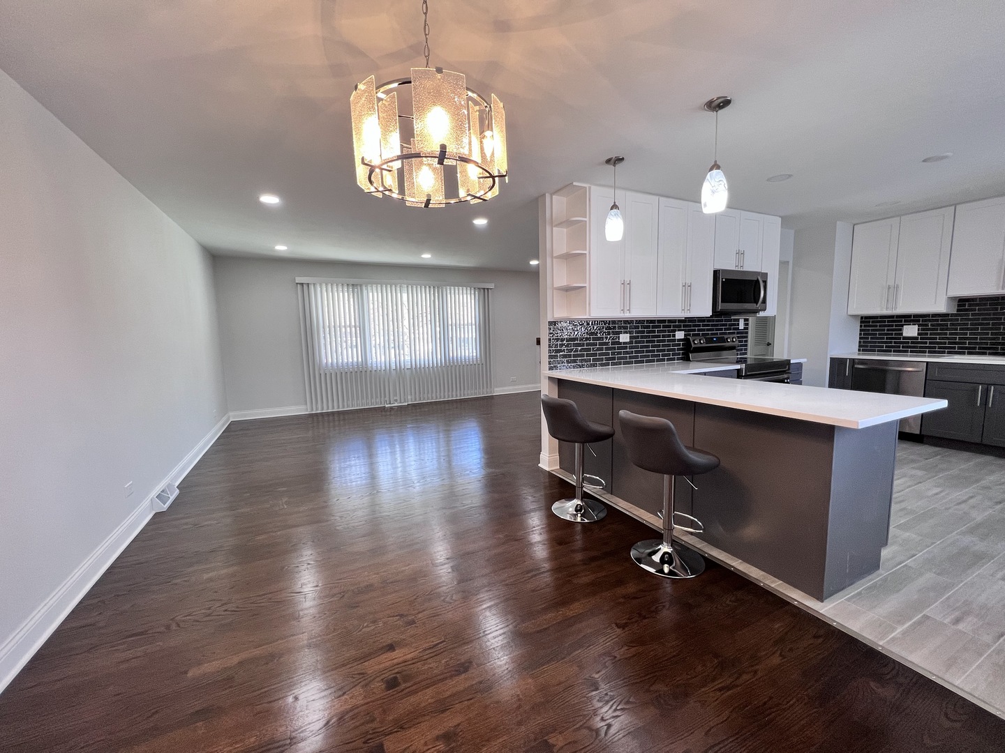 235 North Rohlwing Road Palatine, IL 60074 - Photo 9 of 35 an open kitchen with wooden floor and stainless steel appliances