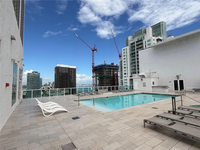 a swimming pool with outdoor seating and yard