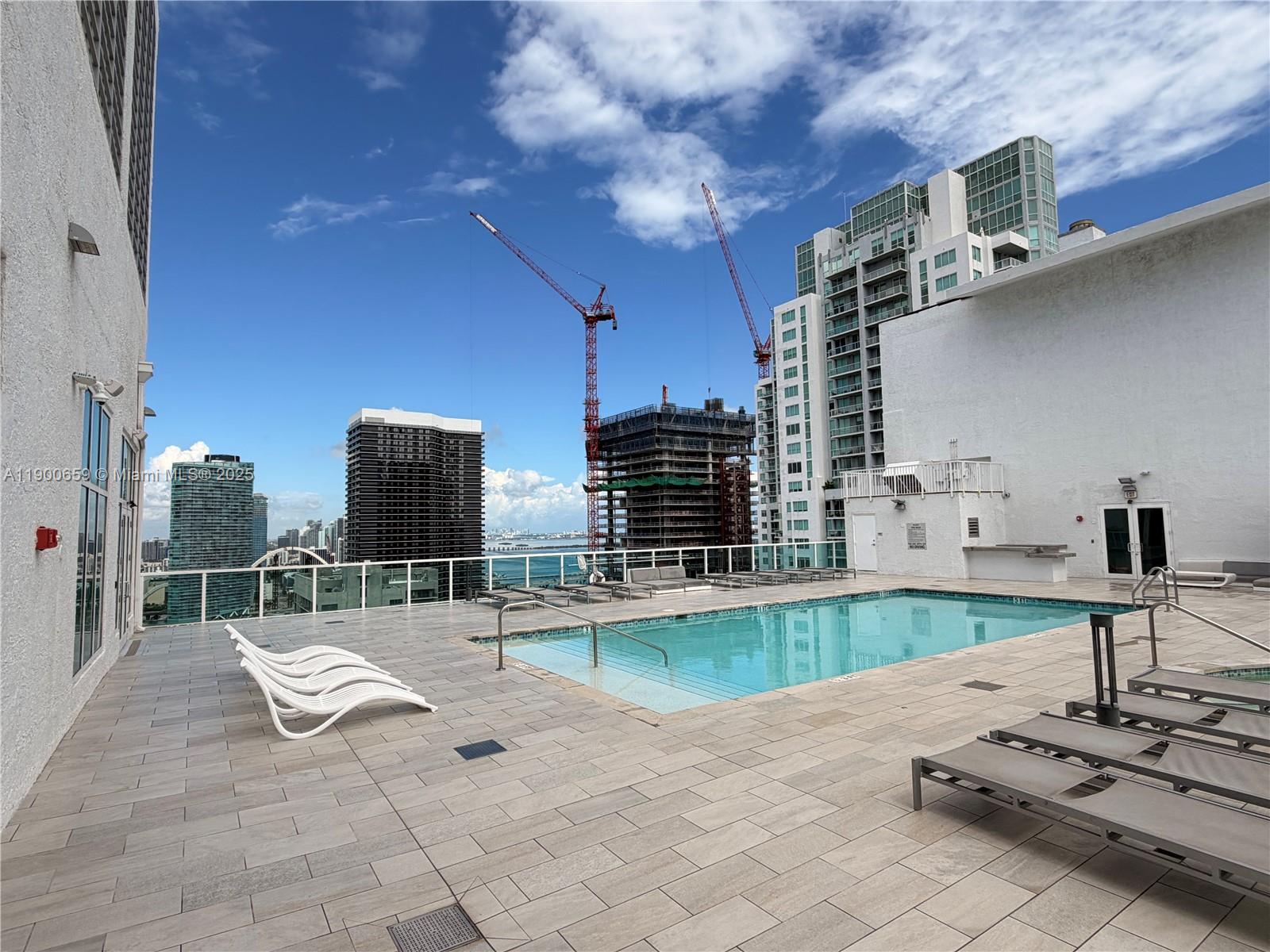 133 Northeast 2nd Avenue, Unit 209 Miami, FL 33132 - Photo 16 of 20 a swimming pool with outdoor seating and yard