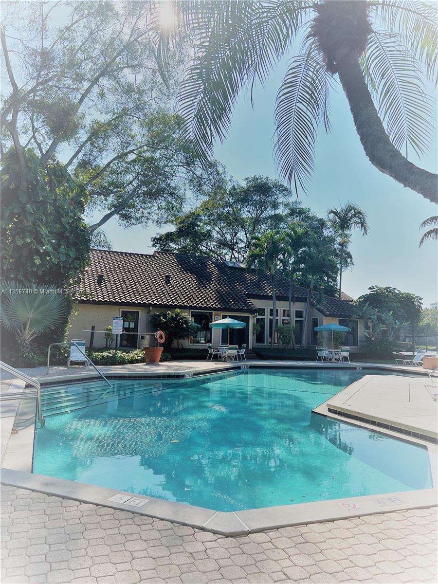 4361 West McNab Road, Unit 21 Pompano Beach, FL 33069 - Photo 15 of 18 a front view of a house with garden