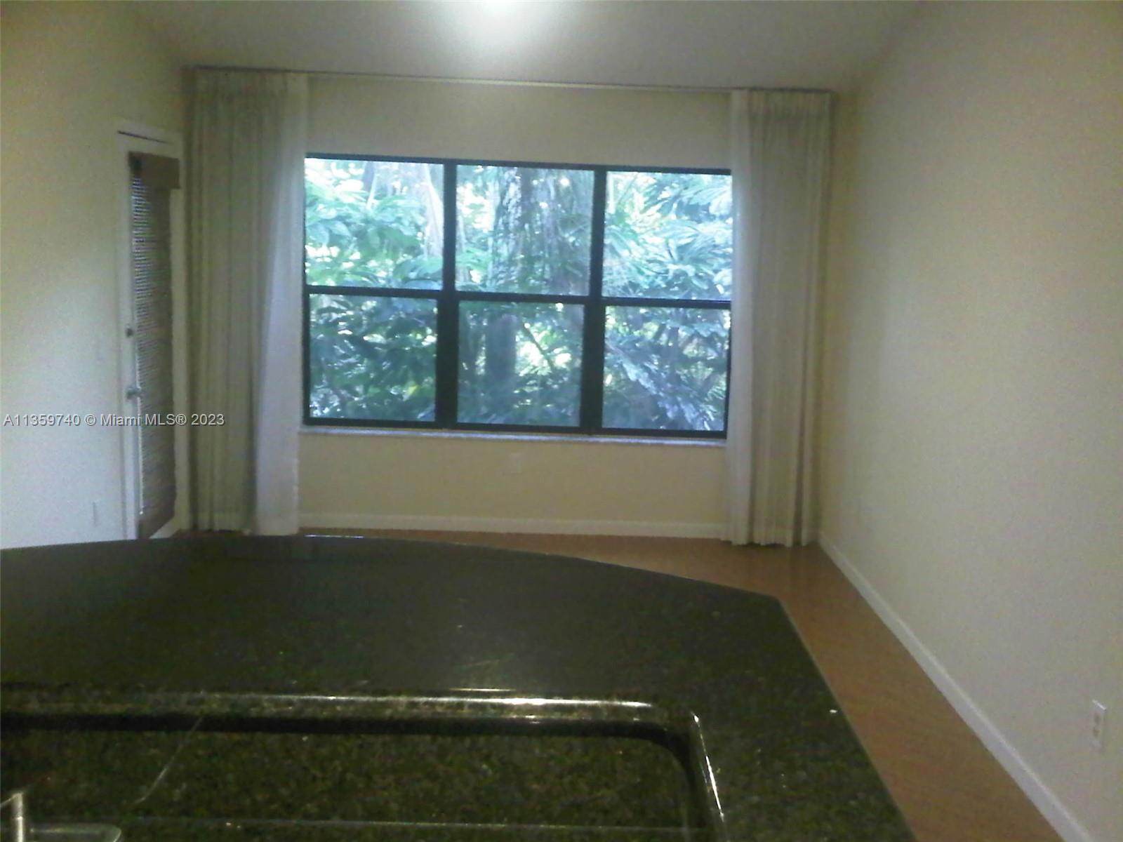 4361 West McNab Road, Unit 21 Pompano Beach, FL 33069 - Photo 7 of 18 an empty room with a window