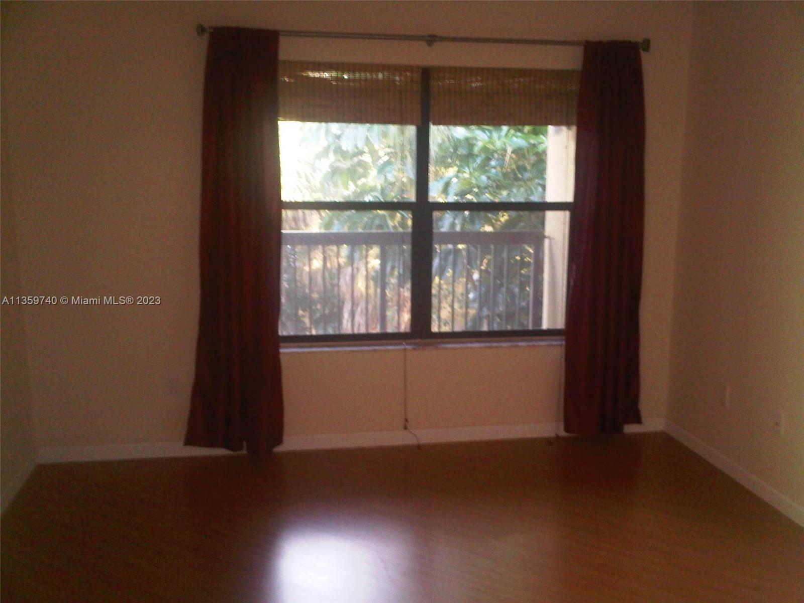 4361 West McNab Road, Unit 21 Pompano Beach, FL 33069 - Photo 8 of 18 a view of empty room with wooden floor and fan