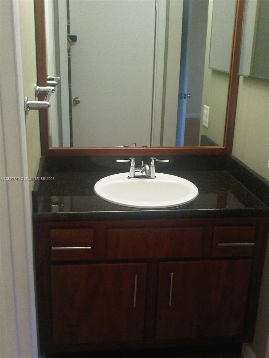 4361 West McNab Road, Unit 21 Pompano Beach, FL 33069 - Photo 9 of 18 a bathroom with a sink and a mirror