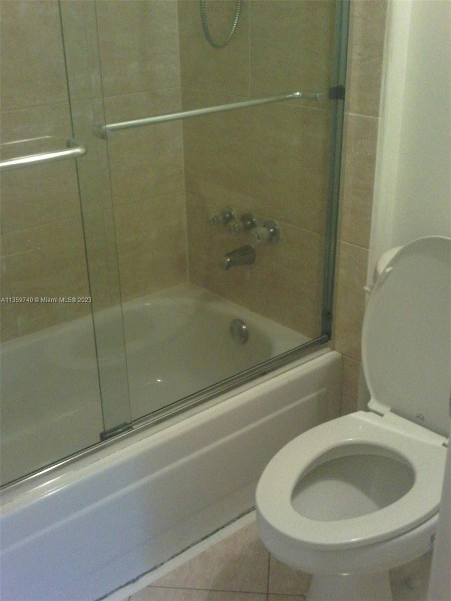 4361 West McNab Road, Unit 21 Pompano Beach, FL 33069 - Photo 10 of 18 a bathroom with a shower and a toilet