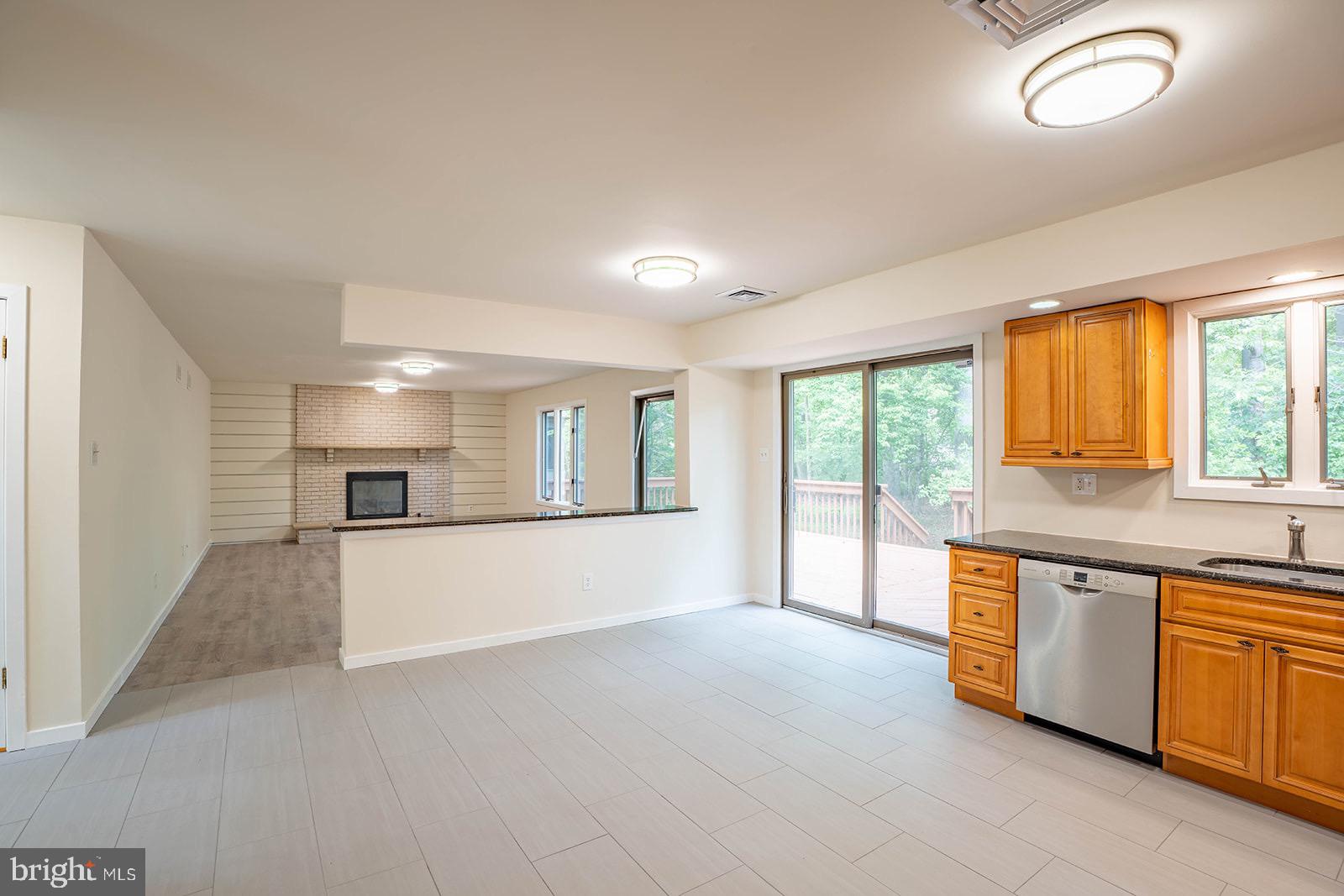 491 Kings Road Yardley, PA 19067 - Photo 18 of 52 a large white kitchen with stainless steel appliances granite countertop a sink and a stove