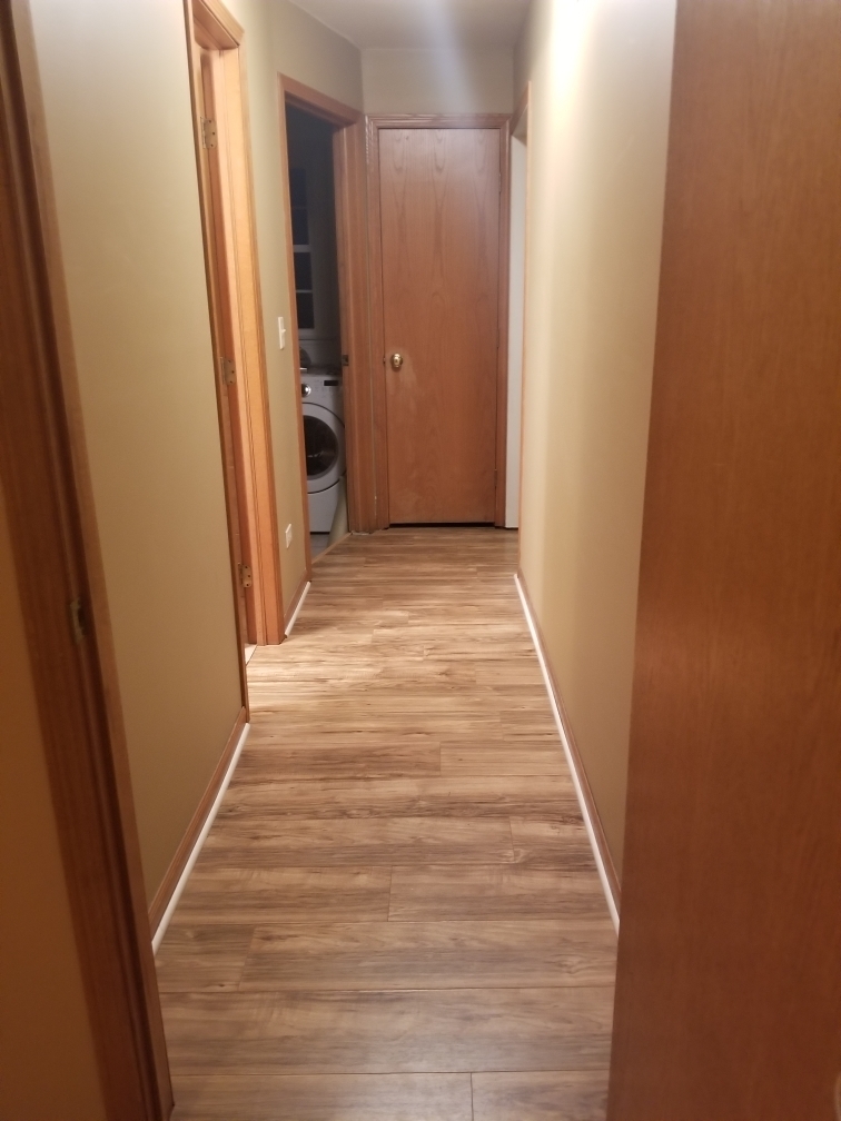6110 Birmingham Street Chicago Ridge, IL 60415 - Photo 20 of 20 a view of a hallway with wooden floor and a bathroom
