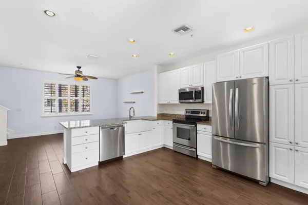 a kitchen with stainless steel appliances a refrigerator sink and microwave