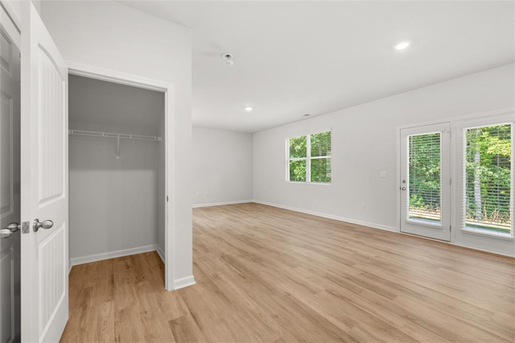 509 Oak View Lane Dallas, GA 30157 - Photo 11 of 35 an empty room with wooden floor and windows