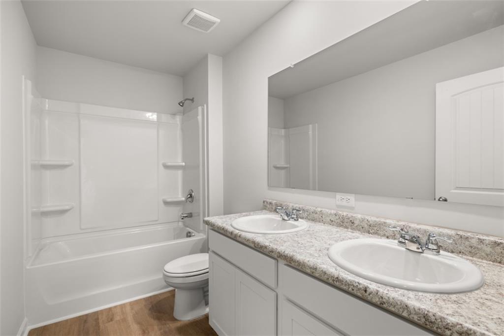 509 Oak View Lane Dallas, GA 30157 - Photo 30 of 35 a bathroom with a granite countertop sink toilet and shower