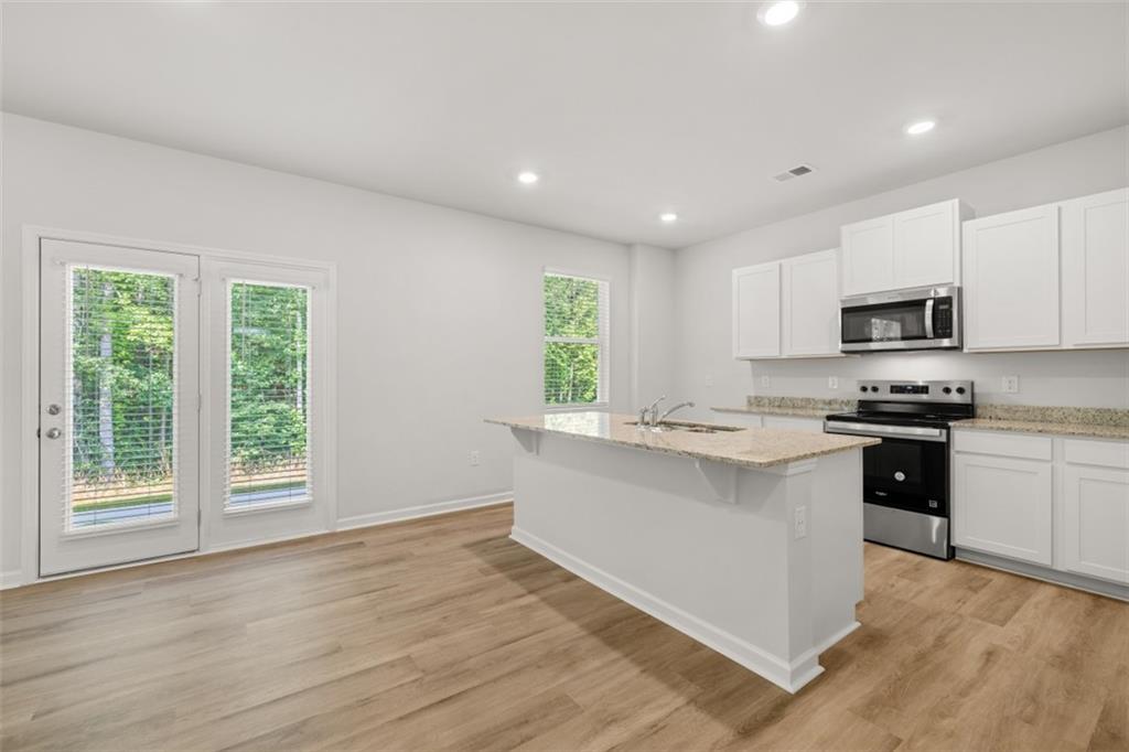 509 Oak View Lane Dallas, GA 30157 - Photo 5 of 35 a kitchen with a sink cabinets stainless steel appliances and a window
