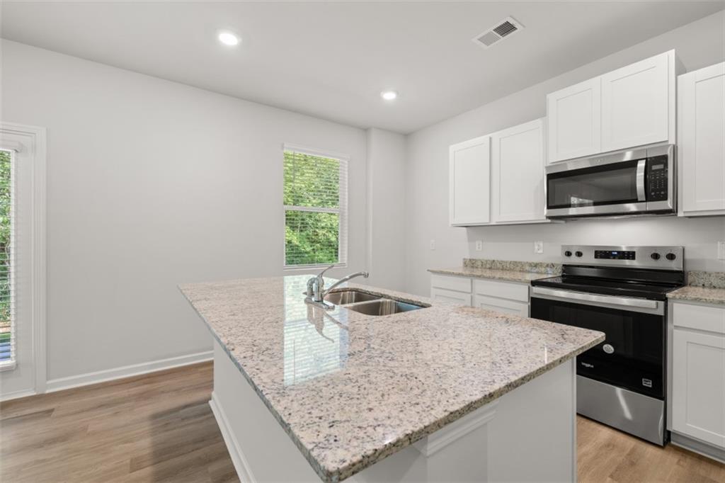 509 Oak View Lane Dallas, GA 30157 - Photo 7 of 35 a kitchen with a stove and a microwave
