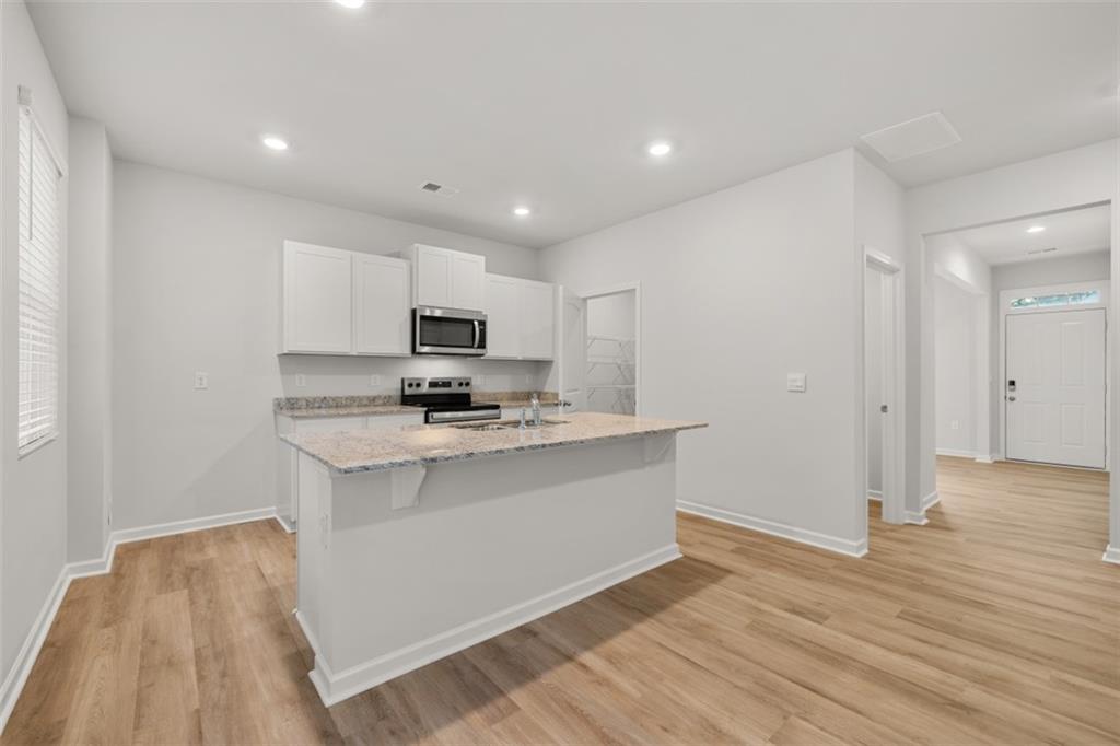 509 Oak View Lane Dallas, GA 30157 - Photo 8 of 35 a kitchen with stainless steel appliances granite countertop a sink stove and refrigerator