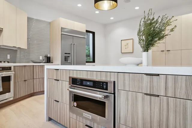 a living room with furniture a flat screen tv and a large window