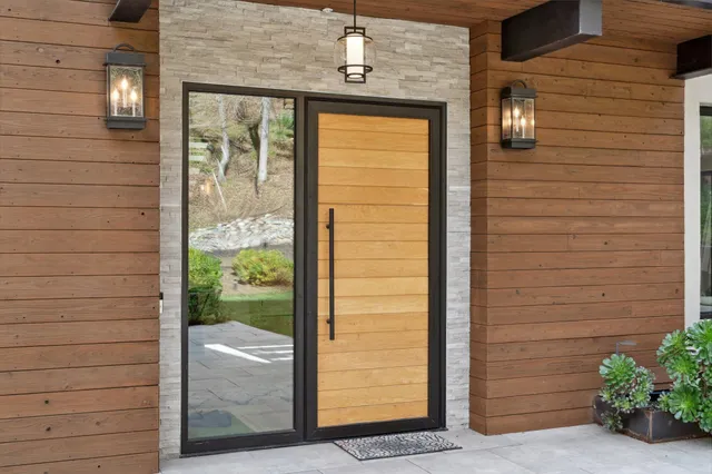 a living room with furniture potted plant and a large window