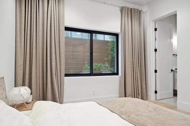 a front view of a house with a tree