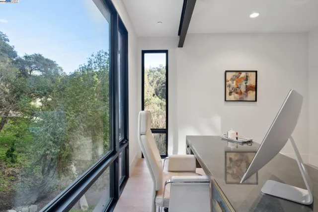 a kitchen with a sink and chairs