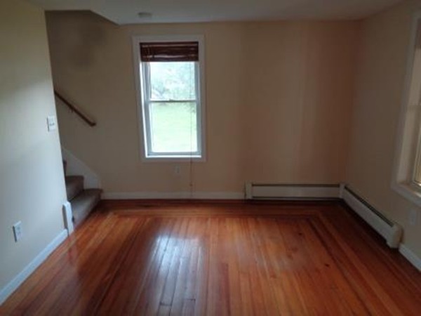 113 Bourne Street Three Rivers, MA 01080 - Photo 7 of 19 an empty room with wooden floor and windows