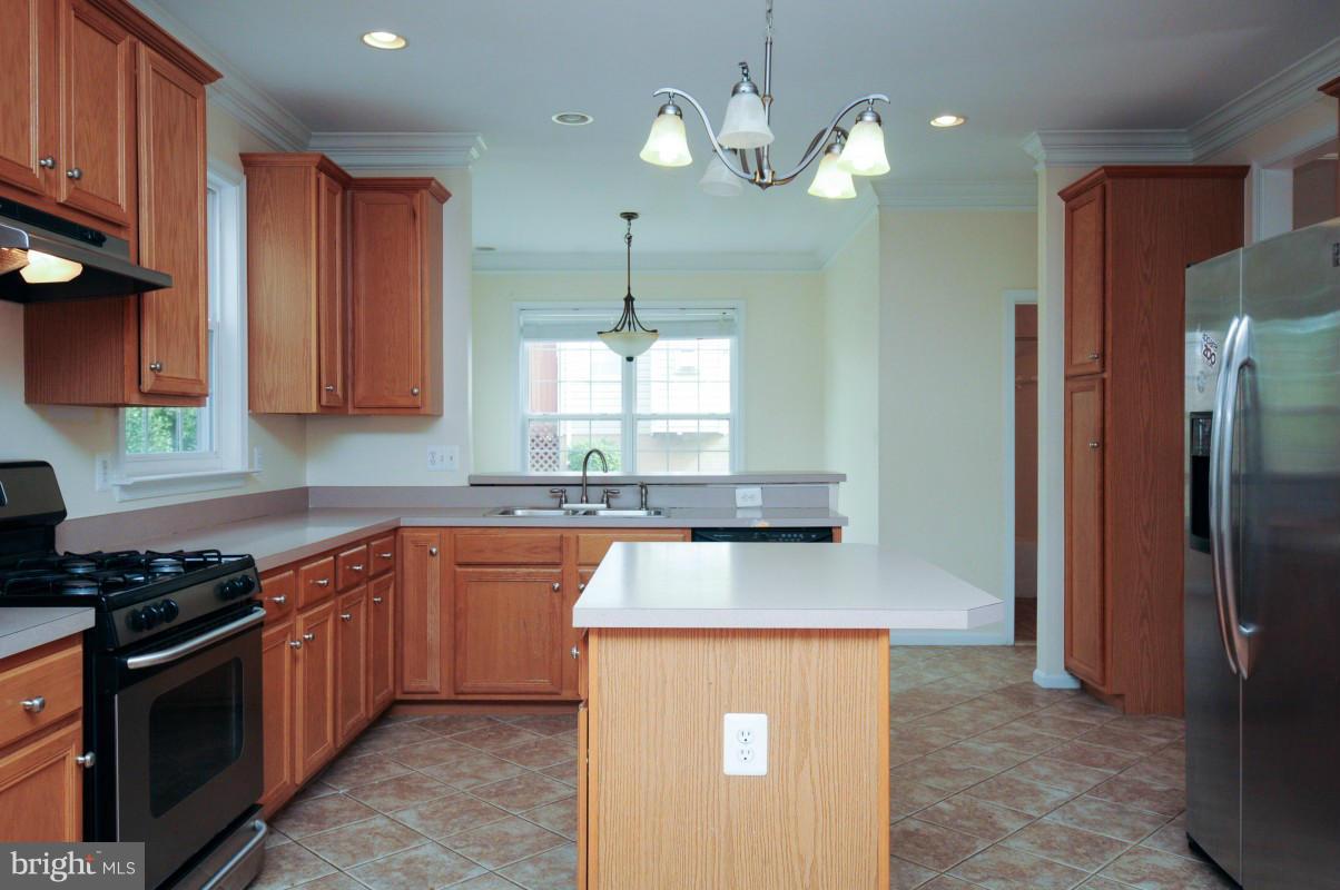 17616 Overlook Road Dumfries, VA 22026 - Photo 12 of 30 a kitchen with stainless steel appliances granite countertop wooden cabinets a stove a sink and a refrigerator