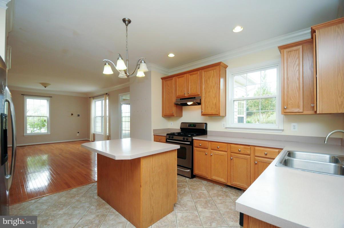 17616 Overlook Road Dumfries, VA 22026 - Photo 13 of 30 a kitchen with stainless steel appliances granite countertop a sink stove and refrigerator