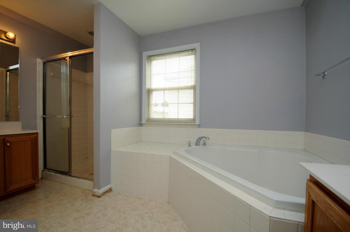 17616 Overlook Road Dumfries, VA 22026 - Photo 23 of 30 a white bath tub sitting in a bathroom next to a window
