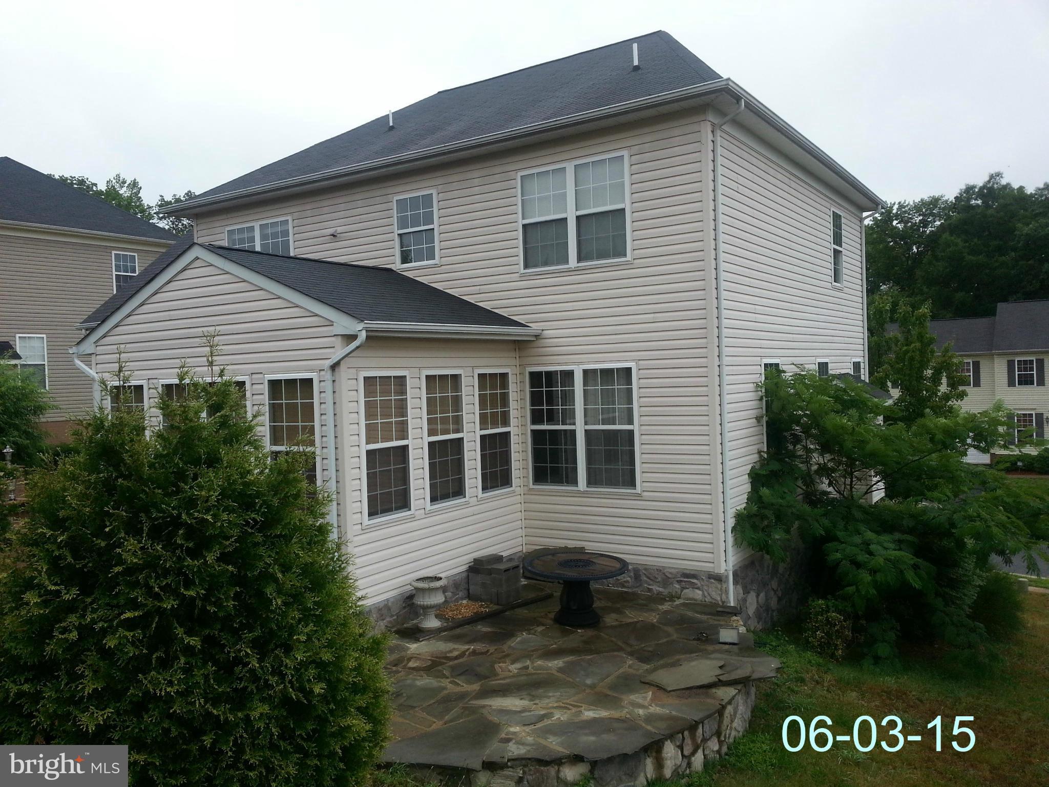 17616 Overlook Road Dumfries, VA 22026 - Photo 27 of 30 a view of a house with a small yard and plants