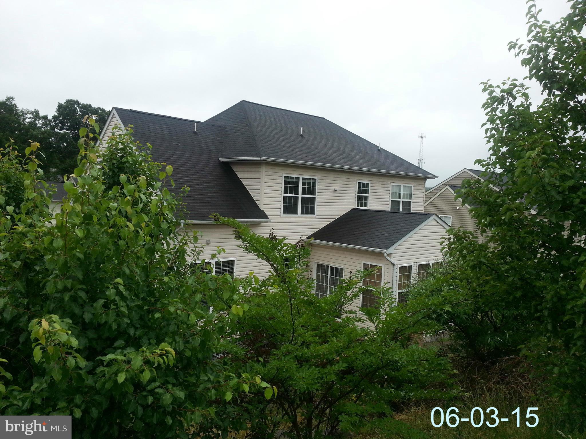 17616 Overlook Road Dumfries, VA 22026 - Photo 29 of 30 a front view of house with yard and trees in the background