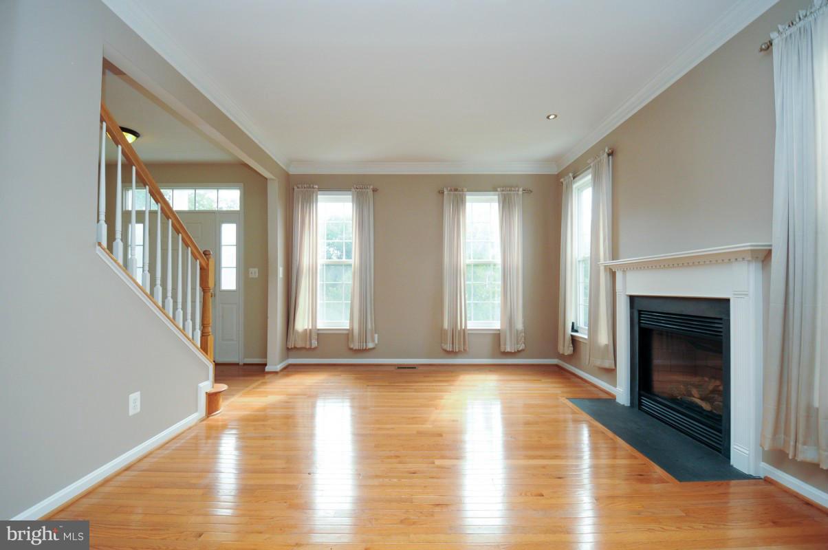 17616 Overlook Road Dumfries, VA 22026 - Photo 7 of 30 a view of an empty room with exposed radiator and fireplace