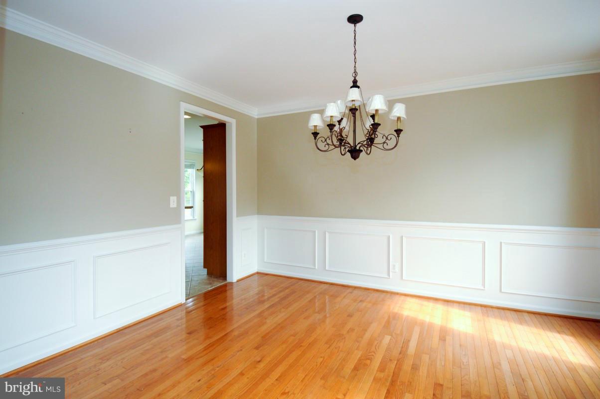 17616 Overlook Road Dumfries, VA 22026 - Photo 9 of 30 a view of a room with wooden floor and chandelier