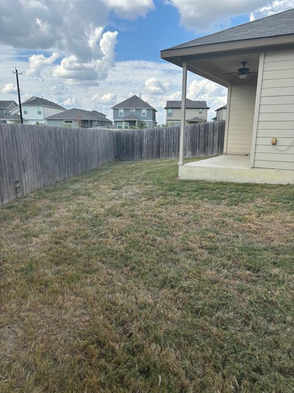 515 Jack Rabbit Lane, Unit A Buda, TX 78610 - Photo 15 of 16 a backyard of a house with lots of green space