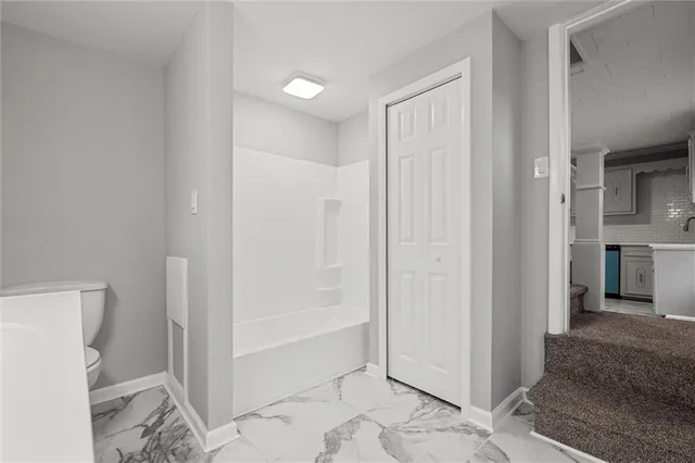 a view of a bathroom with a glass door and shower