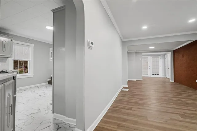 a view of a hallway with wooden floor and staircase