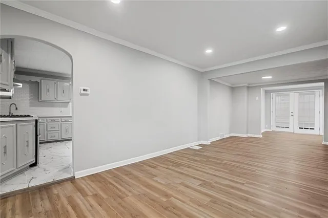 a view of empty room with wooden floor