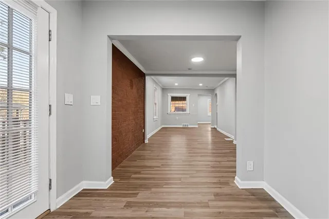 a view of a hallway with wooden floor