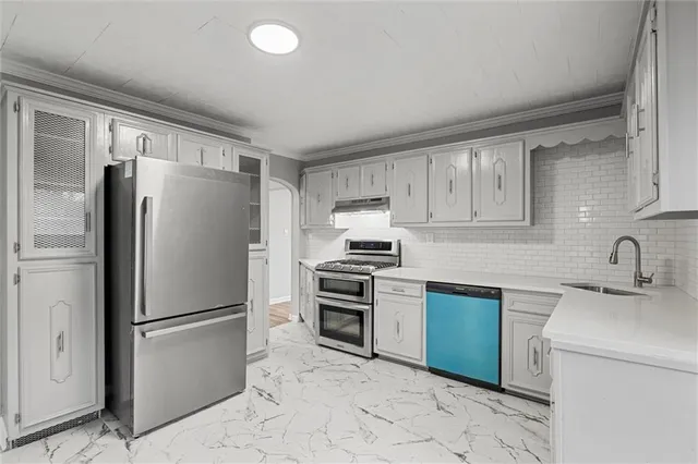 a kitchen with stainless steel appliances granite countertop a refrigerator sink and stove