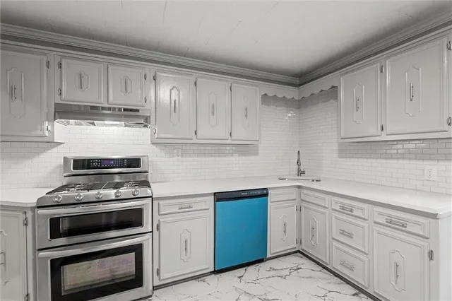 a kitchen with cabinets appliances and a sink