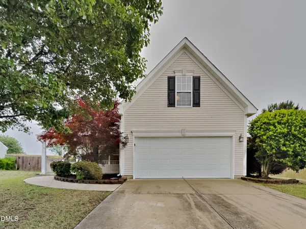 a front view of house with yard and trees