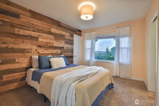 a bedroom with a large bed and a large window