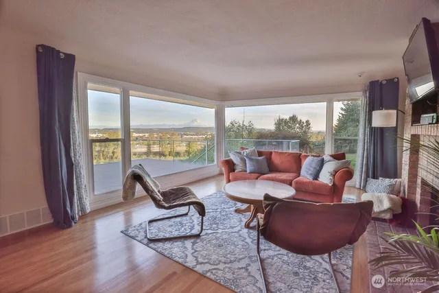 a living room with furniture and floor to ceiling windows