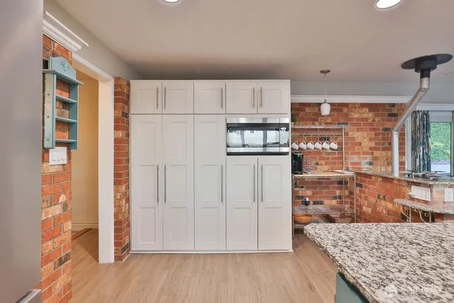 a view of kitchen with furniture and wooden floor