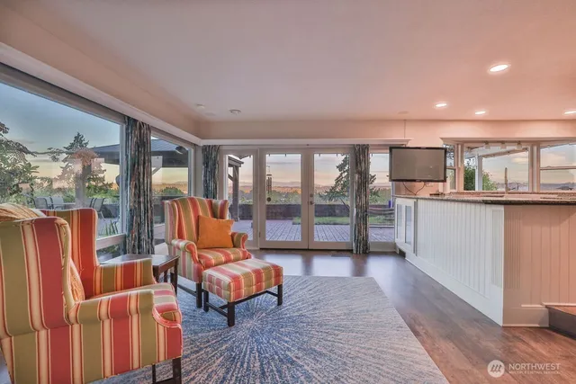 a living room with furniture and a floor to ceiling window