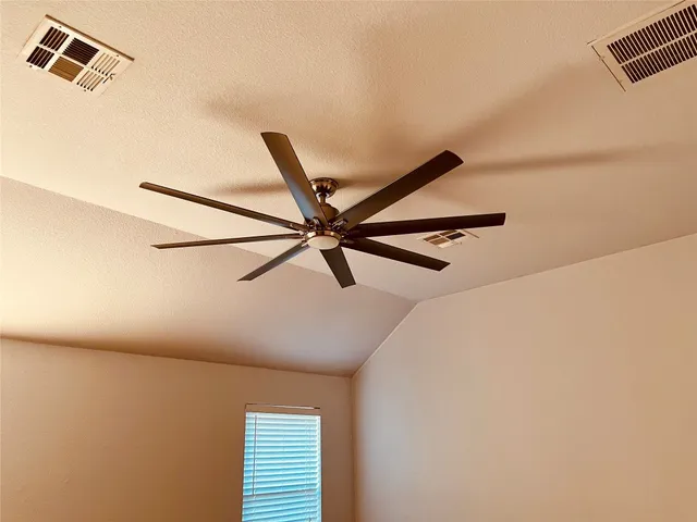 a view of a room with a ceiling fan