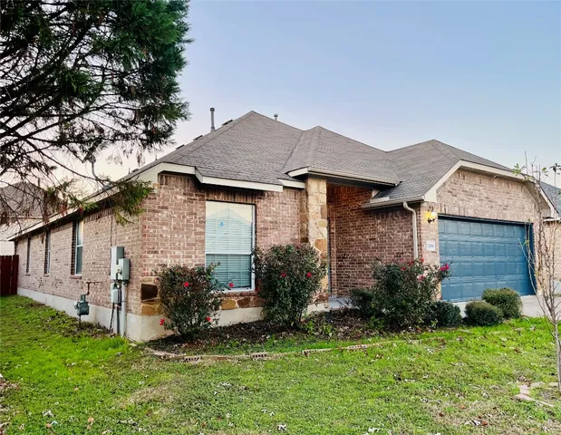 a aerial view of a house with a yard table and chairs