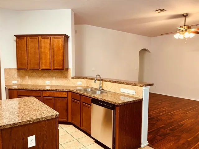 a kitchen with a sink and a wooden cabinets