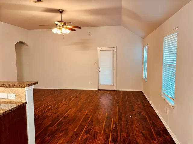 a view of a room with wooden floor and chandelier