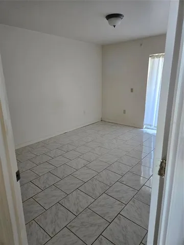 a bathroom with a granite countertop toilet and a sink