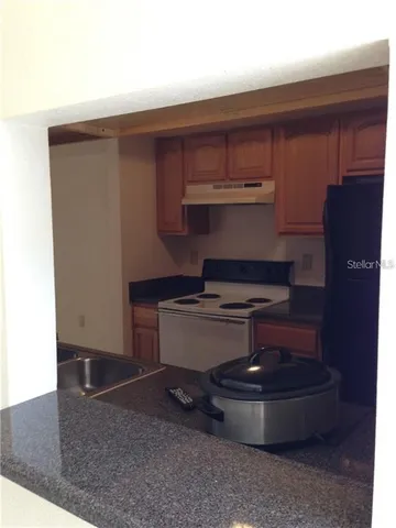 a room with a stove and cabinets