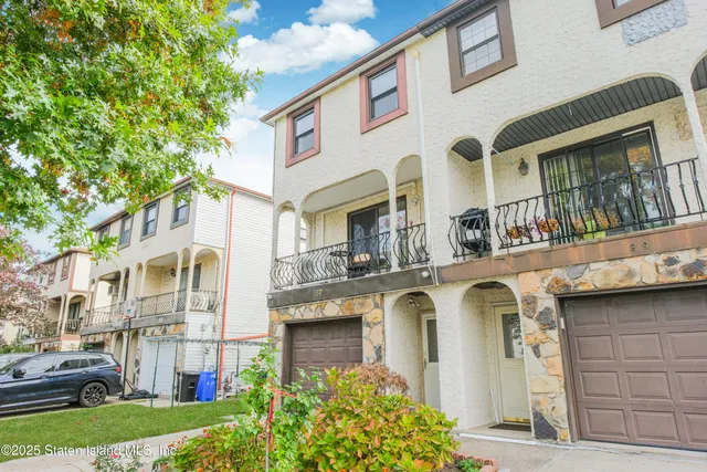 a front view of a residential apartment building with a yard
