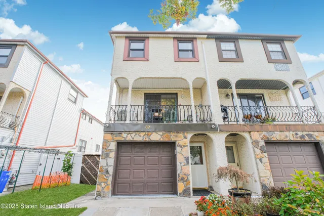 a front view of residential houses with outdoor space