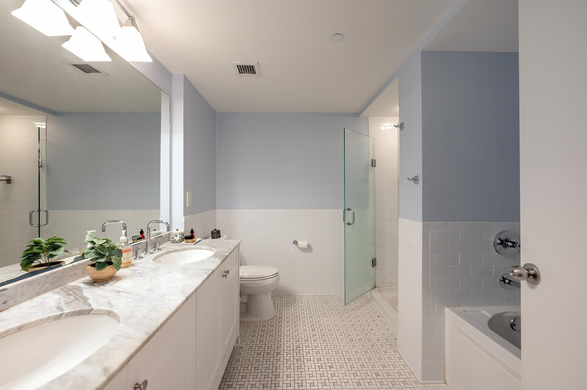 700 Grove Street, Unit 10A Jersey City, NJ 07310 - Photo 16 of 24 a bathroom with a granite countertop sink a toilet and shower