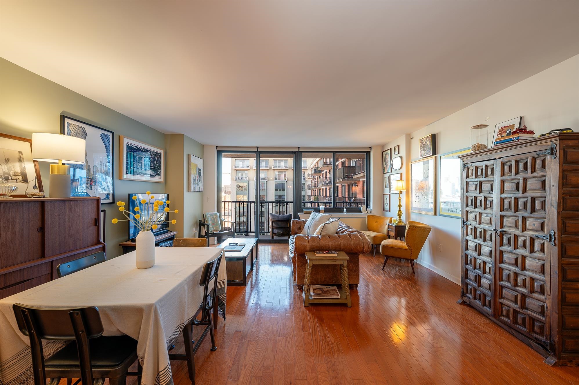 700 Grove Street, Unit 10A Jersey City, NJ 07310 - Photo 2 of 24 a living room with furniture a rug potted plant and a large window